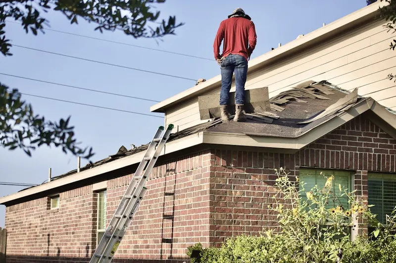 Professional roofer working on a residential roof in Northeast Elgin